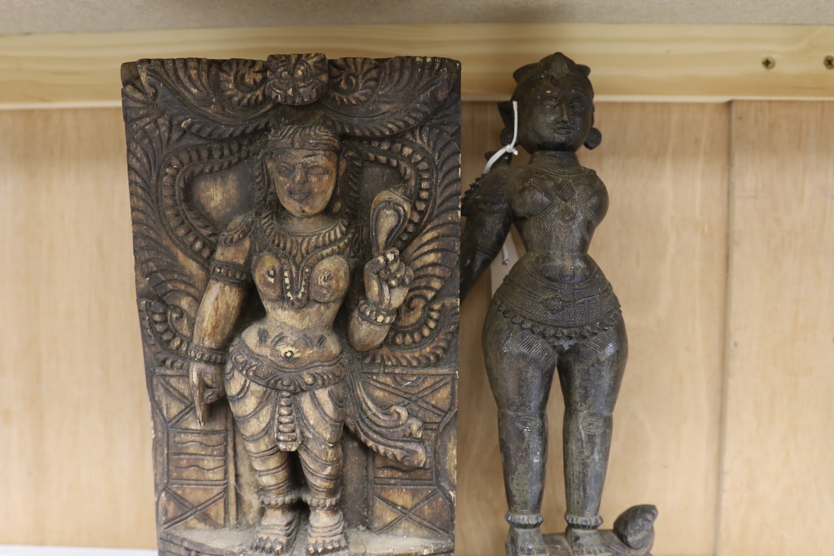 Two Indian carved stone deity heads and two Indian carved figures of Hindu deities, tallest 32cm